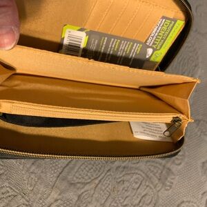 Black RFID zip wallet, 11 card slots, 2 open & 1 zip pockets, & wristlet strap.